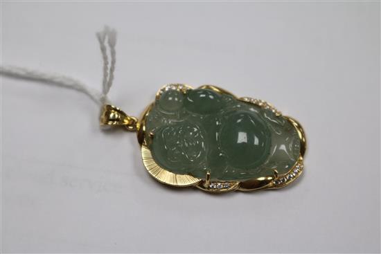 An 18k gold mounted jadeite Buddha pendant, 34mm.